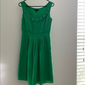 Green A-line dress with front pleats.